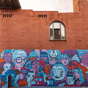 we are one mural on brick building