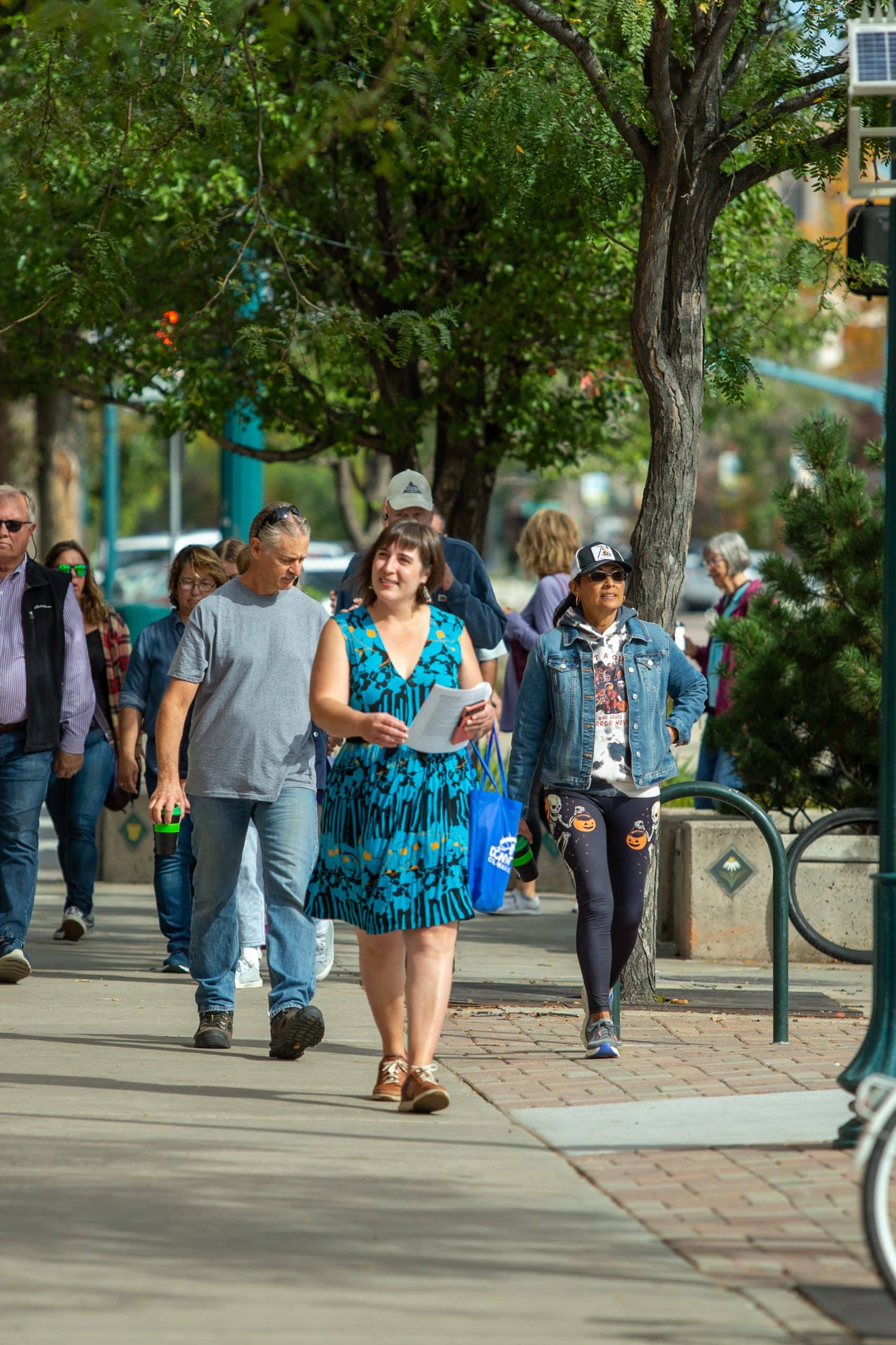Group of people walking on sidewalk
