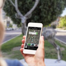 Tourist using navigation app and maps on the mobile phone.